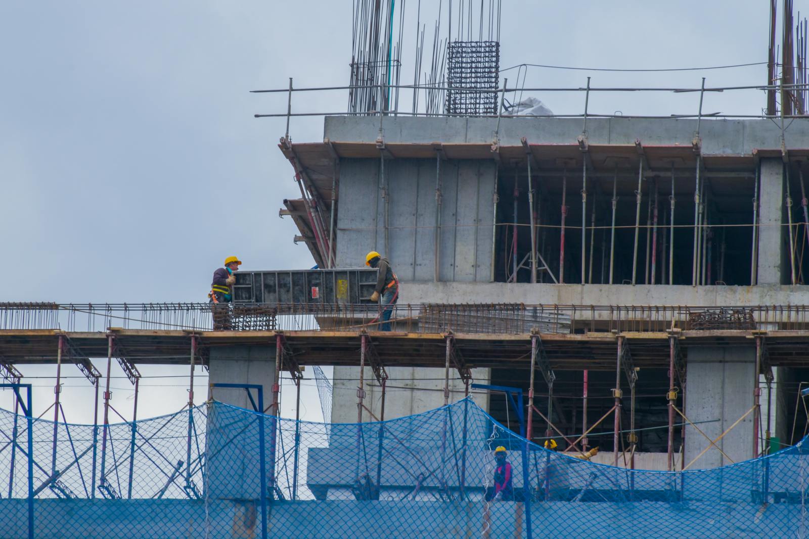 Construction workers on scaffolding at an active job site