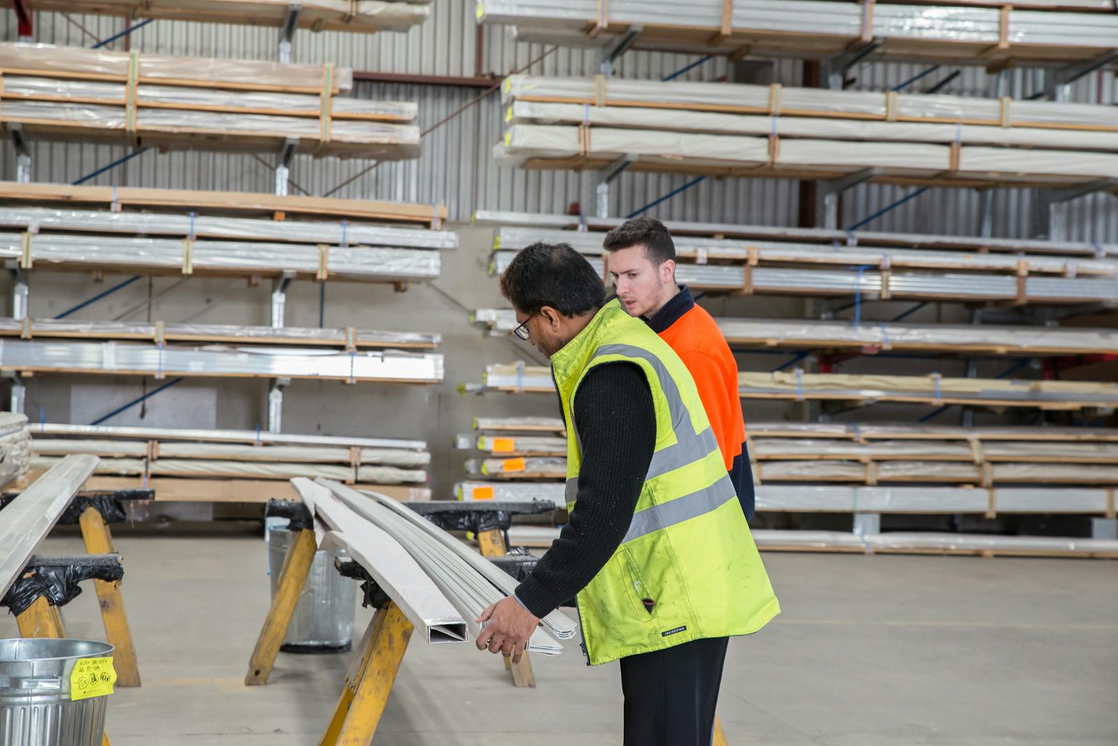 Workers inspecting construction materials in a warehouse